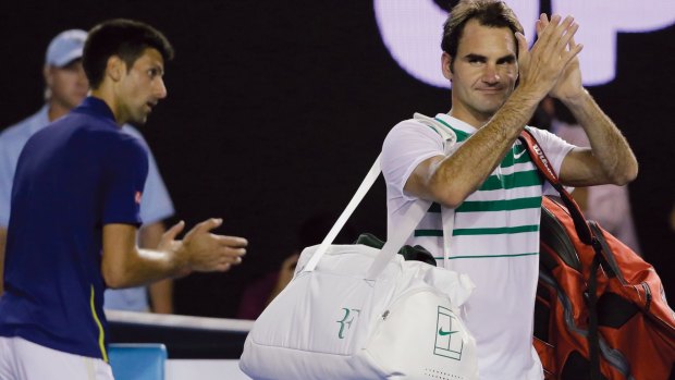 Fond farewell: Roger Federer applauds the crowd as he leaves Rod Laver Arena.