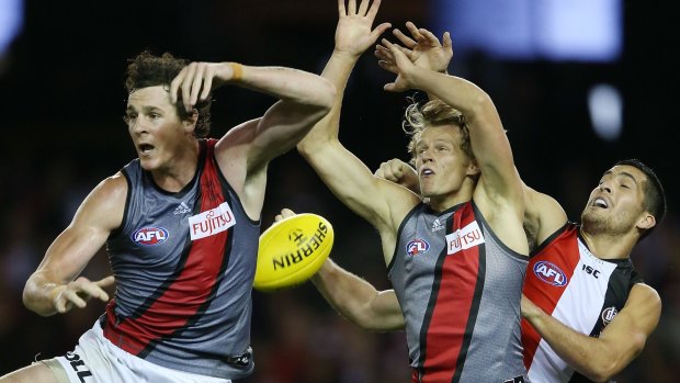 MELBOURNE, AUSTRALIA - MAY 03:  Jake Carlisle (L) and Martin Gleeson of the Bombers of the Bombers compete for the ball against Shane Savage of the Saints (R) during the round five AFL match between the St Kilda Saints and the Essendon Bombers at Etihad Stadium on May 3, 2015 in Melbourne, Australia.  (Photo by Michael Dodge/Getty Images)