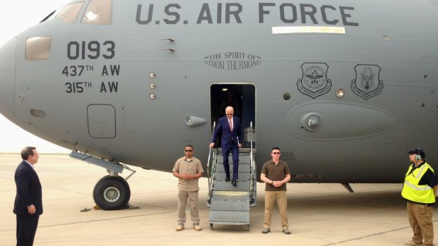 US Vice-President Joe Biden steps off a C-17 military transport plane upon his arrival in Baghdad on Thursday.