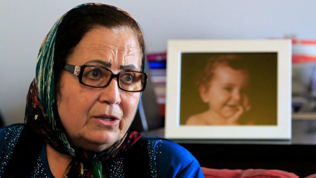 Ibtisam Berri with a picture of her granddaughter Lahala Elamine, at her home in the southern suburbs of Beirut.