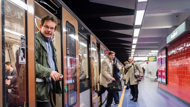 Commuters arrive at Maelbeek metro station in Brussels on April 2016 for the first time since the March 22 attacks.