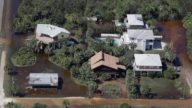 In this aerial photo, streets are flooded near homes in Flagler Beach, Florida. 