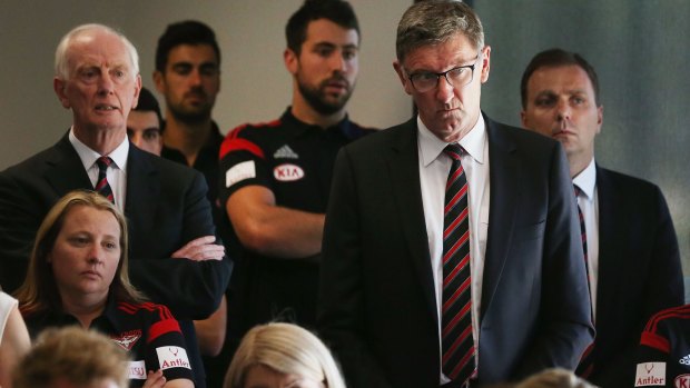 Essendon legend Simon Madden (second right) listens during a press conference at the club on Tuesday.