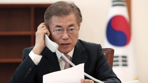 South Korean President Moon Jae-in talks on the phone with Chinese President Xi Jinping on May 11.