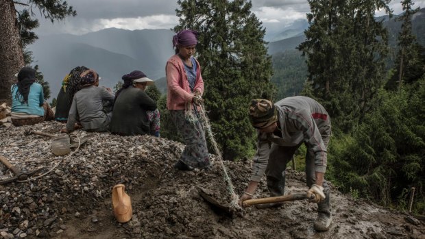 Indian labourers hired by their country's military work on a road improvement project in Haa, Bhutan, near a border area claimed by both India and China.