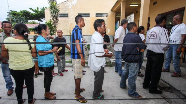 People queue to vote voluntarily in East Timor presidential elections in Farol, Dili, on Monday.