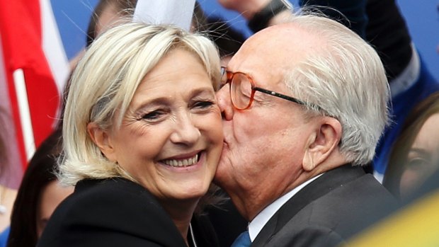 Happier days: Jean-Marie Le Pen (R), France's National Front political party founder, embraces his daughter Marine Le Pen, National Front political party leader, after her speech at their traditional rally in Paris in 2013.