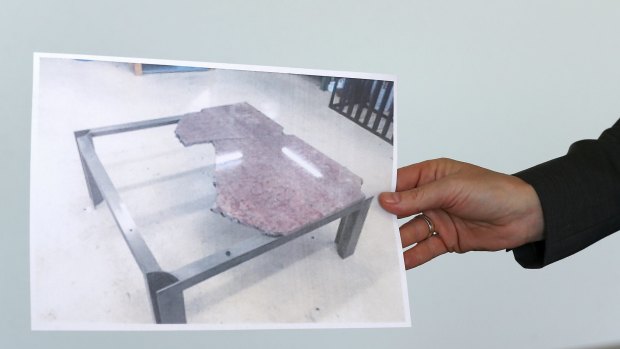 A photograph of the damaged table.