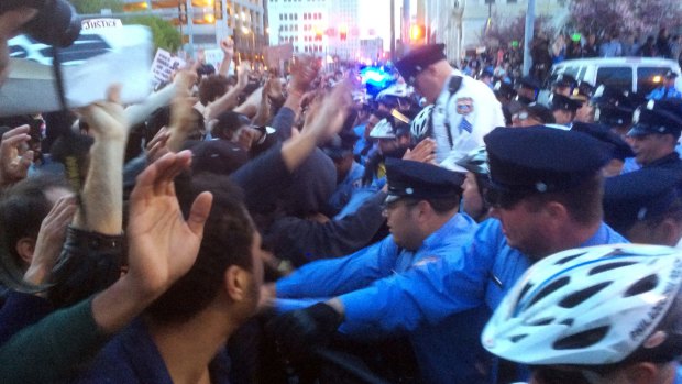 Protesters rush a police line in Philadelphia on Thursday, following unrest in Baltimore.