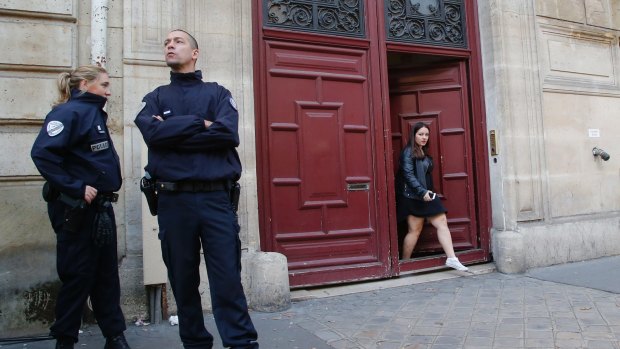 French police officers outside the "No Name Hotel" in Paris following the robbery.