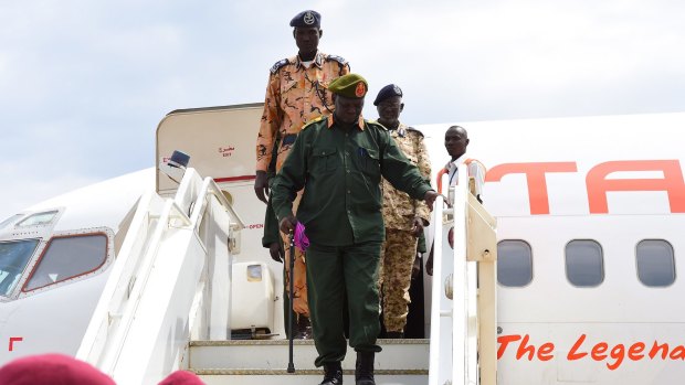 Simon Gatwech Dual (centre) arrives at Juba Airport, in an important step for South Sudan's fragile peace process.