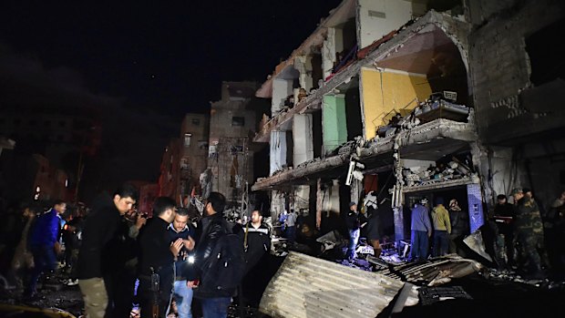 People gather in the aftermath of a multiple explosive attack in the Sayyida Zeinab area, 10km south of Damascus, Syria, on Sunday.