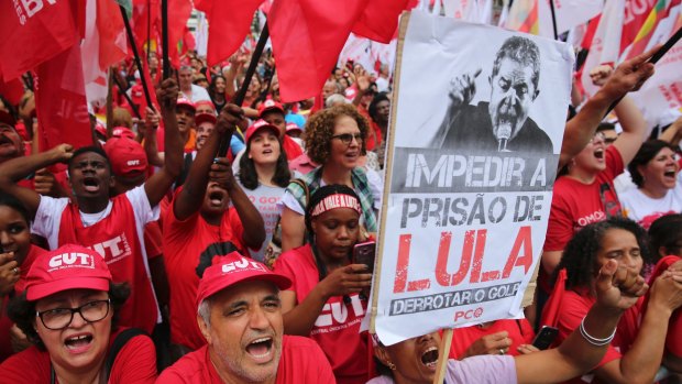 Labour union members shout slogans in support of Brazilian former President Luiz Inacio Lula da Silva in Sao Paulo on Wednesday. The sign reads: "Stop the jailing of Lula"