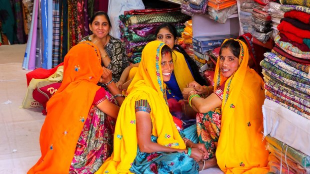 Local women sitting in a store at Johari Bazaar street in Jaipur, Rajasthan.