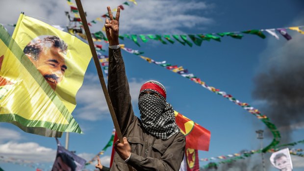 A Kurdish man holds up a picture of PKK leader Abdullah Ocalan in Diyarbakir, Turkey, in March 2015.