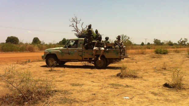 Nigerian soldiers drive past the Government secondary school in Chibok in 2014, following the mass kidnapping.