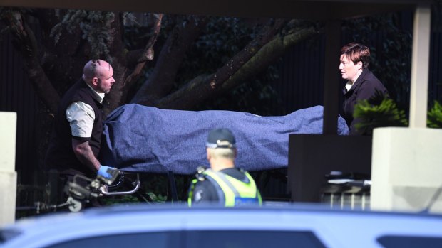 Coroners remove a body from the Brighton apartment block.