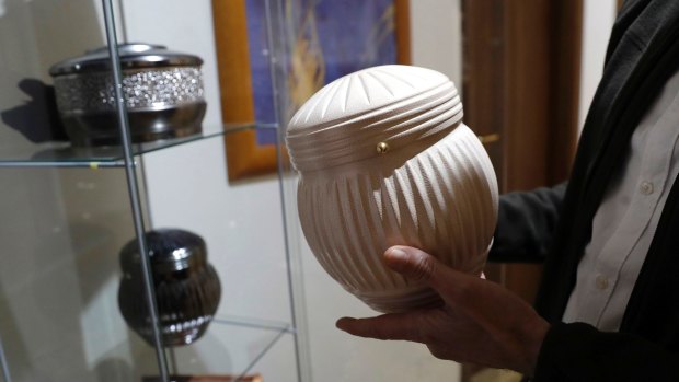 Urn models on display at a funeral parlour in Rome.