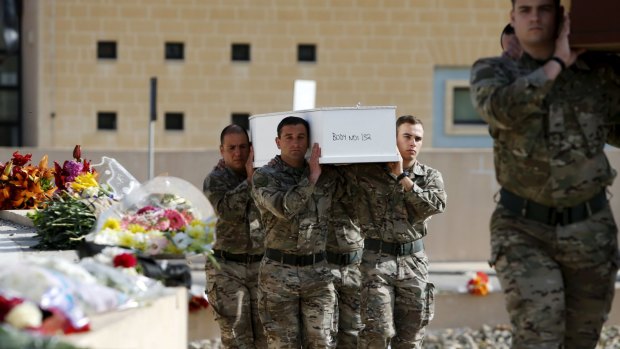 Maltese soldiers carry coffins with the bodies of asylum-seekers on Thursday.