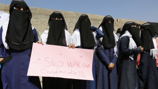 Women hold a banner as they take part in a protest marking International Women's Day in front of the UN building in Sanaa, Yemen.