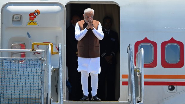 Indian Prime Minister Narendra Modi arrives at Brisbane Airport to attend the G20 Leader's Summit on November 14, 2014. The G20 Leader's Summit being hosted by Australia in Brisbane will be held from November 15-16. AFP PHOTO / Greg WOOD