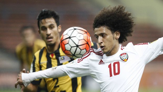 Contest for possession: Omar Abdulrahman, right, of the United Arab Emirates vies for possession against Malaysia's Matthew Davies during the Group A World Cup 2018 qualifying match in Shah Alam on Tuesday.