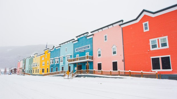 Colourful buildings contrast with the snowy landscape in Dawson City.