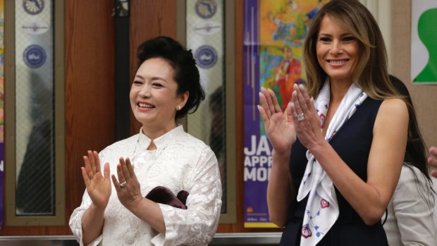 US first lady Melania Trump and her Chinese counterpart Peng Liyuan enjoy a musical performance at the Bak Middle School of the Arts, in West Palm Beach, Florida on Friday.