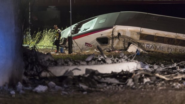 A rescue worker stands near the high-speed train which derailed in Eckwersheim, near Strasbourg, eastern France on Saturday.