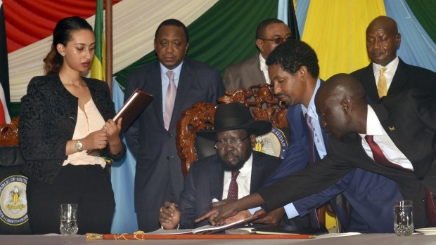 South Sudan President Salva Kiir, seated, signs a peace deal on Wednesday, watched by Kenya's President Uhuru Kenyatta, centre-left, Ethiopia's Prime Minister Hailemariam Desalegn, centre-right, and Uganda's President Yoweri Museveni, right. 