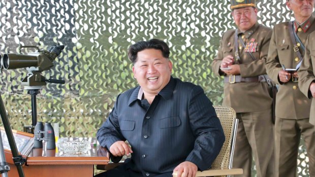 North Korean leader Kim Jong Un smiles as he watches a firing contest of anti-aircraft artillery personnel in this photo released by North Korea's news agency.