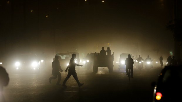 Pedestrians on a busy road in New Delhi, India. 