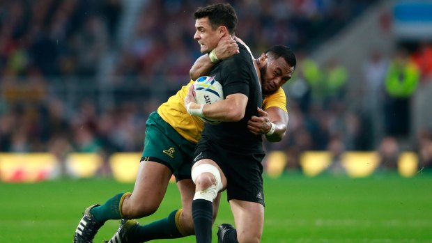 Dan Carter is tackled by Sekope Kepu during the 2015 Rugby World Cup final between New Zealand and Australia at Twickenham.