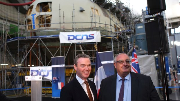Minister for Defence Industry Christopher Pyne, and DCNS chief executive Herve Guillou, at the shipyards in Cherbourg, western France