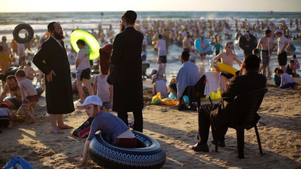 Ultra-Orthodox Jewish men and boys spend the day on a segregated beach in Netanya, Israel, earlier this month. 