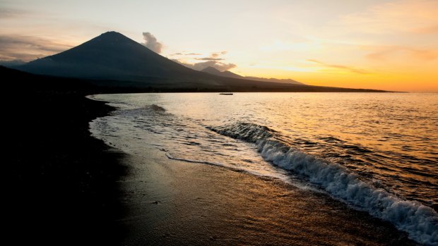 The active volcano, Gunung Agung, looms large in the background of this sunset beach scene taken in Jemeluk, Amed, Bali.