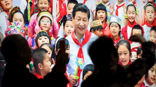 A picture of Xi Jinping with children at an exhibition highlighting China's achievements under five years of his leadership