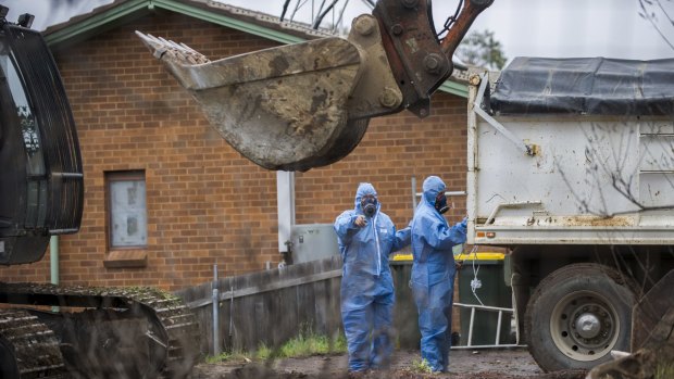 Workers demolish a Mr Fluffy home in Woden Valley, ACT, in 2014.