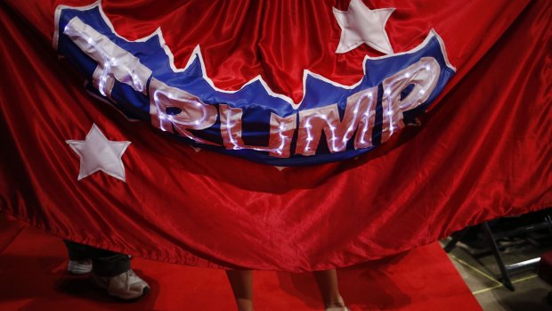 A delegate wears a Trump cape on the third day of the convention.