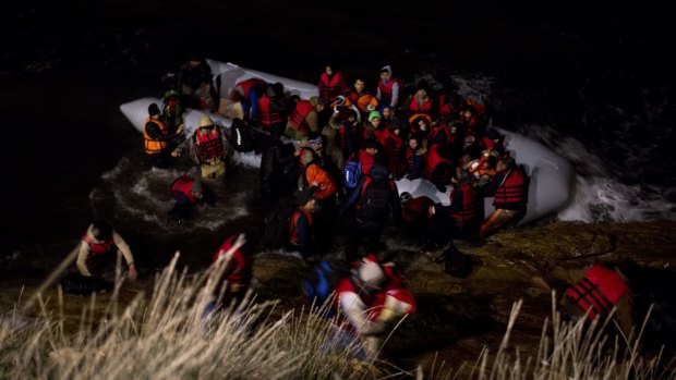 Afghan refugees disembark from a dinghy after crossing a part of the Aegean sea from Turkish coast to the Greek island of Chios on Wednesday. At least 45 drowned on Friday attempting crossings.