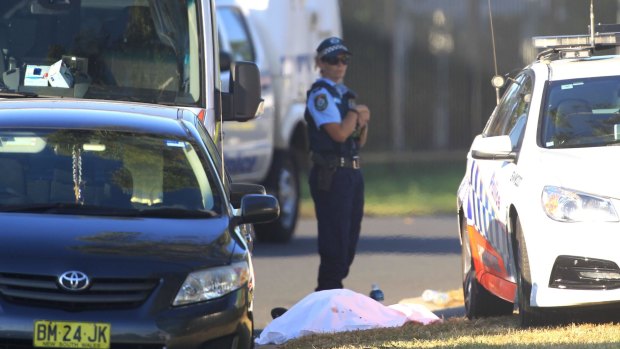 A police officer at the scene of the Ingleburn shooting, guarding what appeared to be a body.