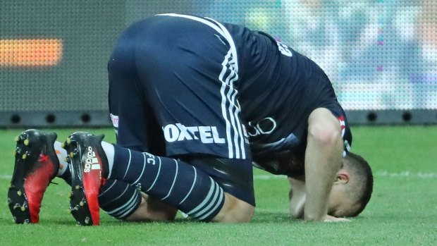 Besart Berisha kisses the ground to celebrate his record-breaking goal.