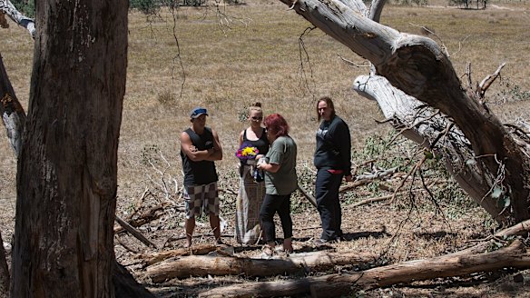 Friends and family leave flowers for the four men.