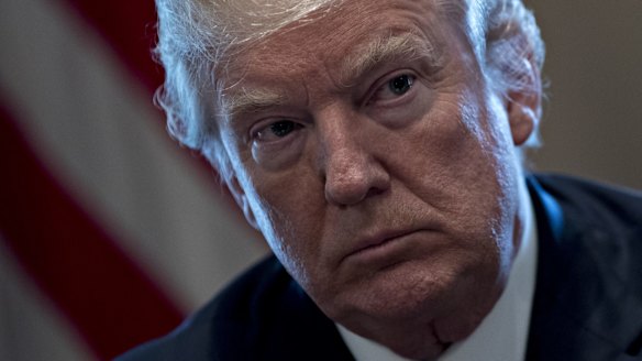 US President Donald Trump listens during a meeting with bipartisan members of Congress on immigration.
