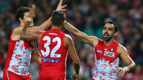 Over she goes: Adam Goodes of the Swans celebrates kicking a goal.