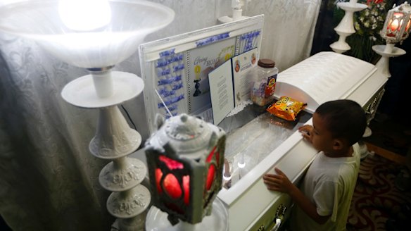 Jomari, a friend of Kian Loyd delos Santos, refuses to leave the wake.