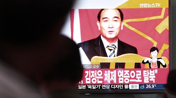 People watch a TV showing a file image of Thae Yong Ho, minister at the North Korean embassy in London.