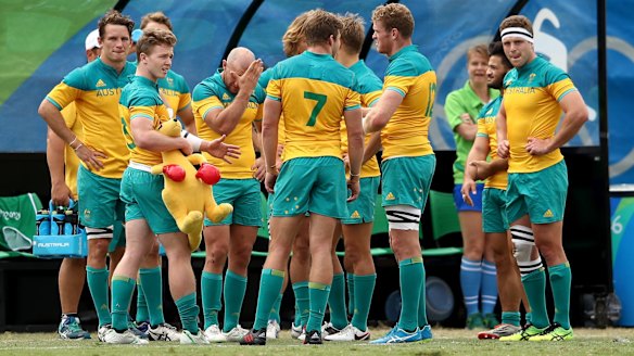 Australian players look dejected in defeat after the Men's Rugby Sevens  match against Argentina.