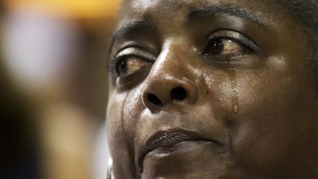 Barbara Lloyd of Charleston cries during the singing of 'We Shall Overcome' at a memorial service for the victims.