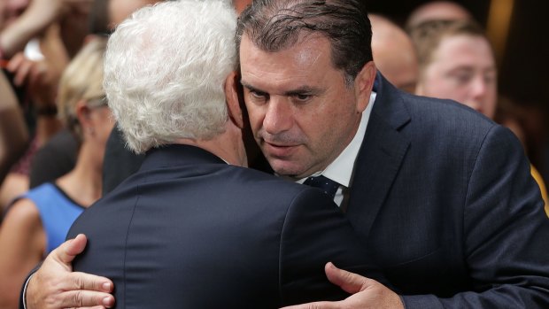 Mission accomplished: FFA chairman Frank Lowy and Ange Postecoglou embrace during celebrations at Westfield Sydney on February 1.